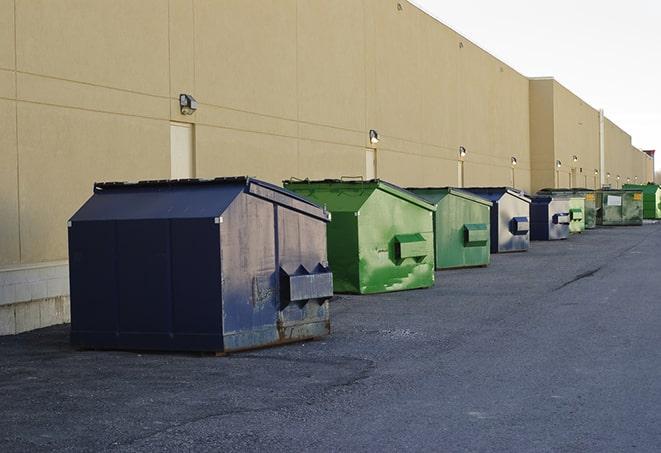 a crowd of dumpsters of all colors and sizes at a construction site in Belle Glade, FL